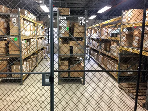 Storage racks behind a wire cage