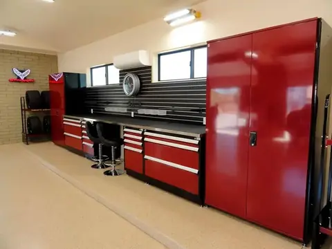 Red modular drawer cabinets and workstations in a service bay
