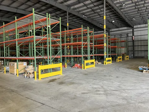 Rows of pallet racking with wire decking and end-of-aisle guards